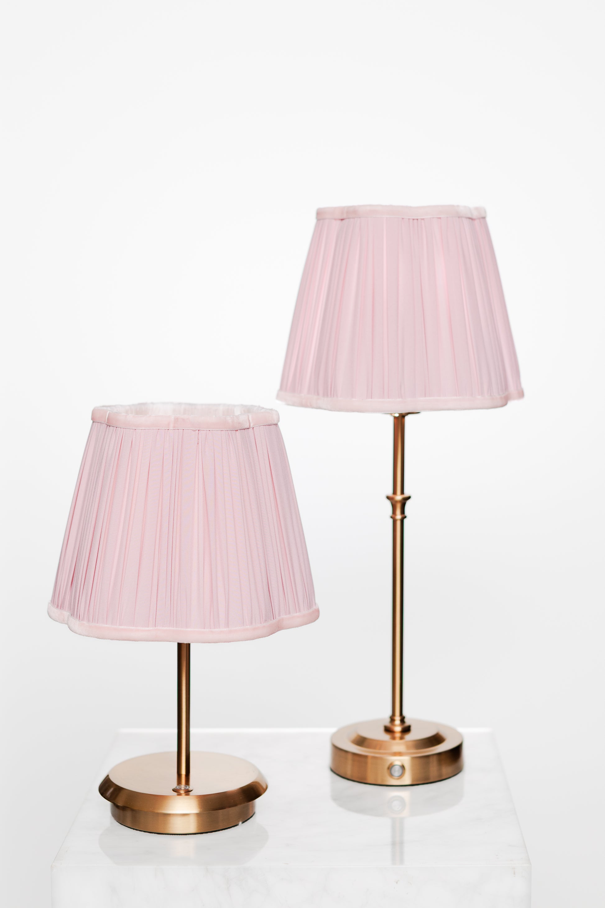 Calm interior corner with brass lamp on side table and plant.