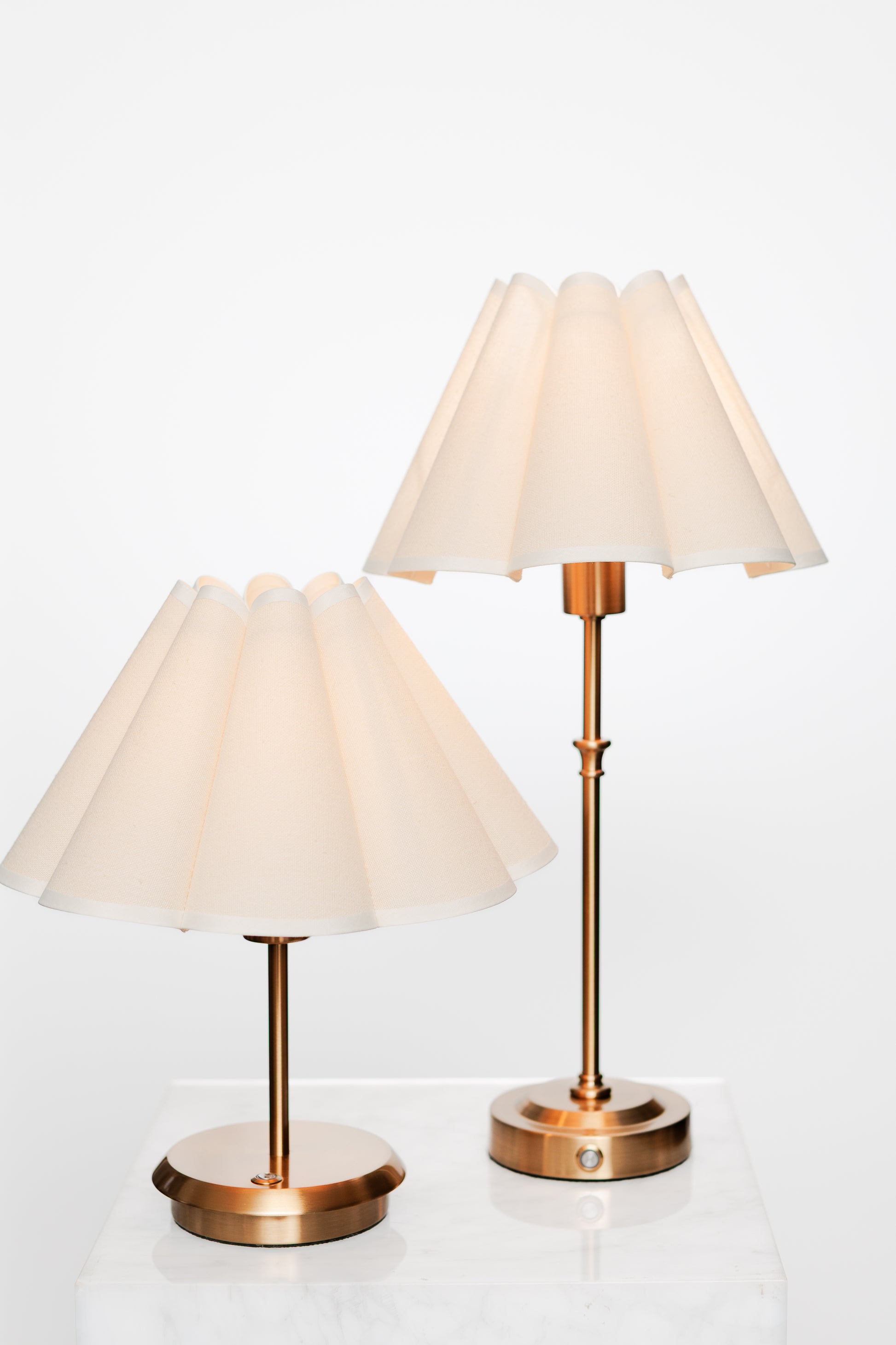 Neutral reading corner with brass lamp, open book, and cozy ambiance.