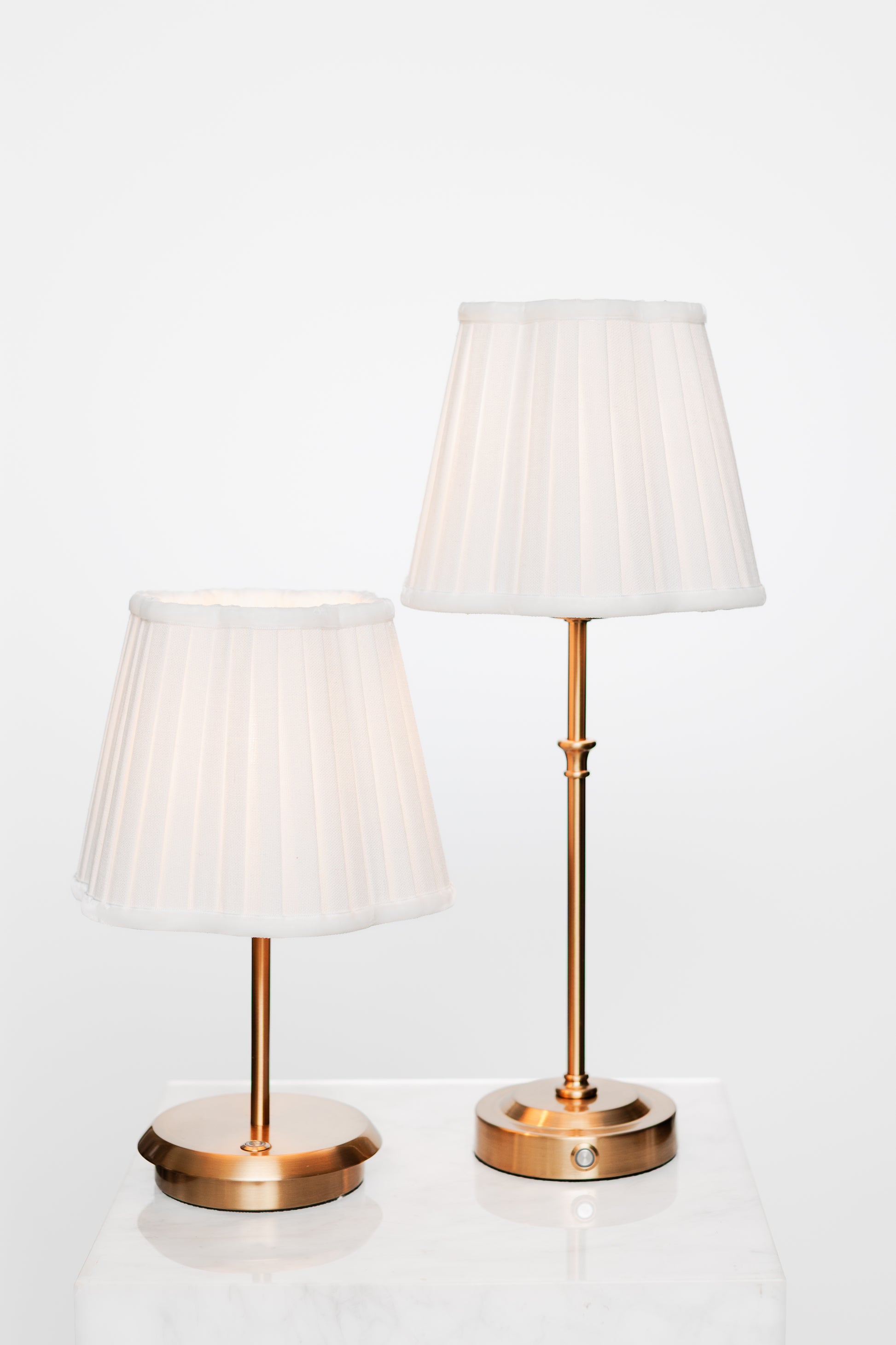 Serene room corner with brass lamp, stack of books, and calm décor palette.