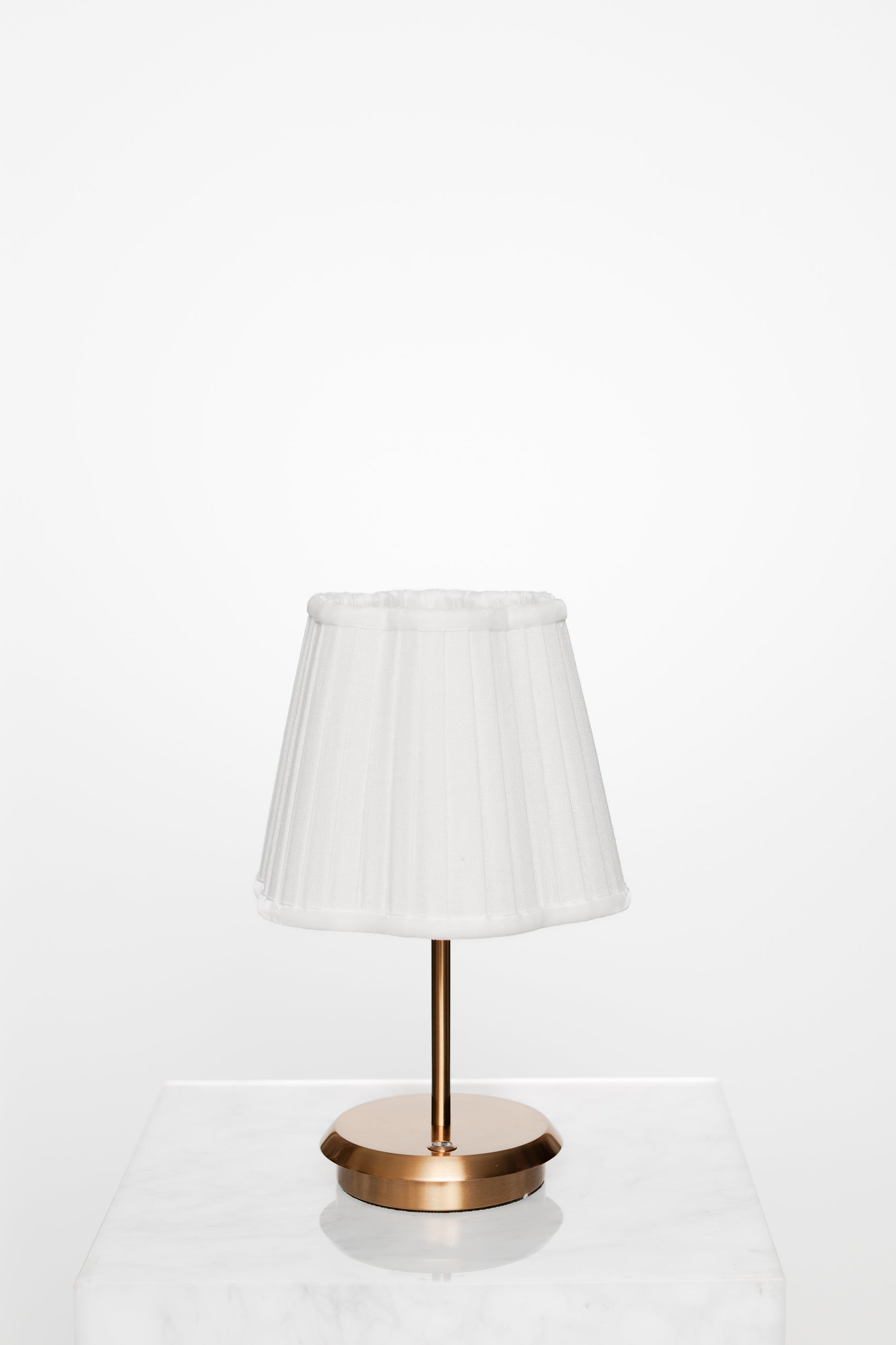 Simple corner with brass lamp, open book, and calm ambience.