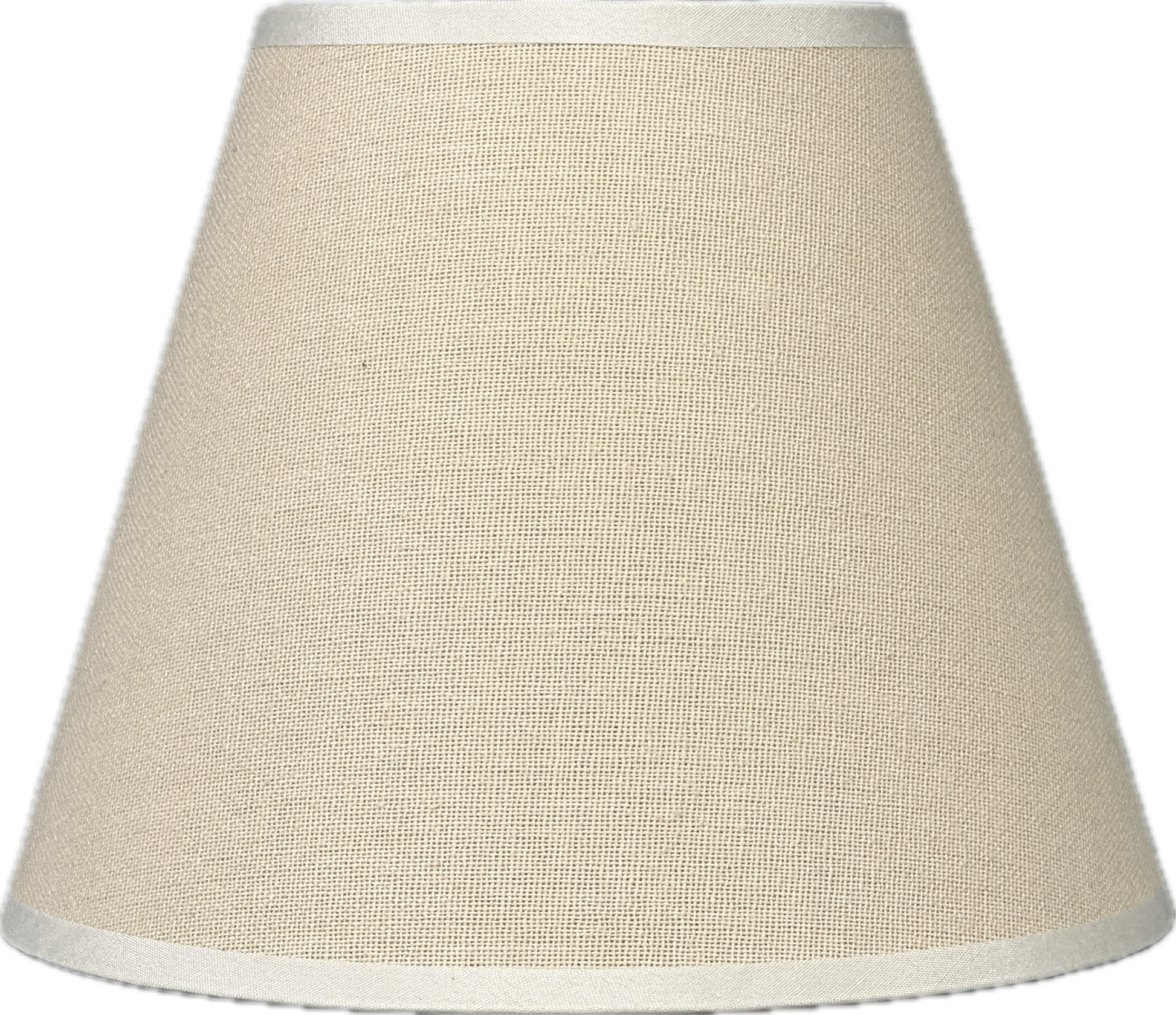 Cozy nook with pleated lamp, soft cushions, and textured rug under warm light.