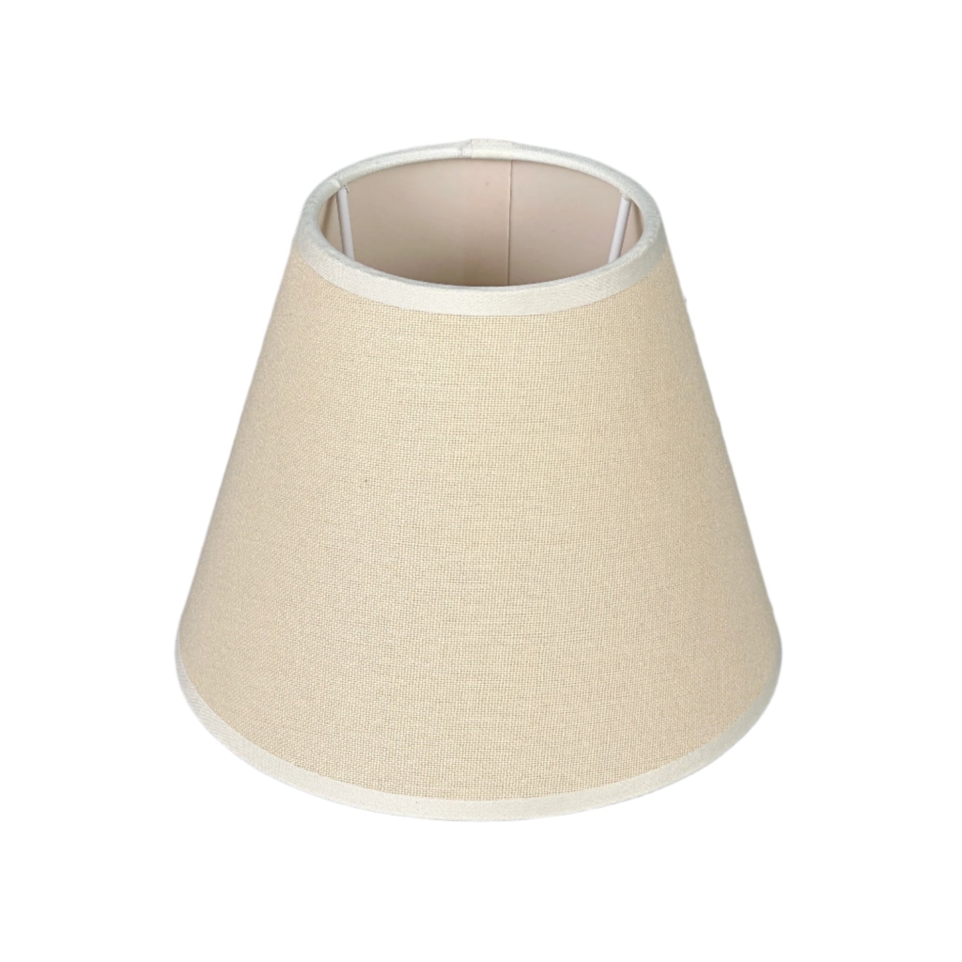 Bright dining nook with brass table lamp, wicker chair, and plant.