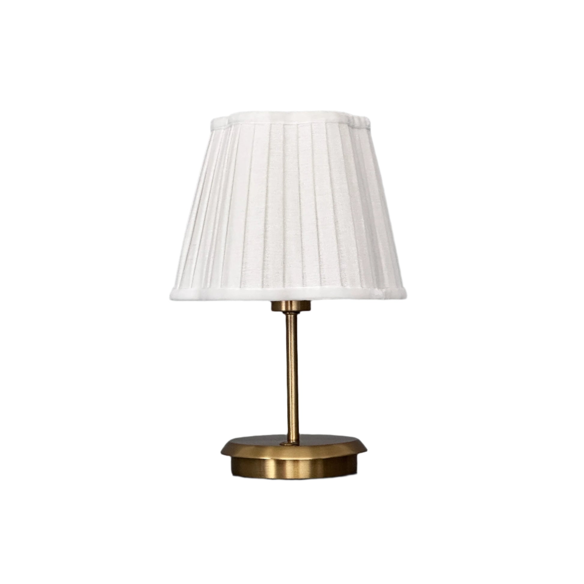 Dimly lit interior space with brass lamp providing warm focal light.