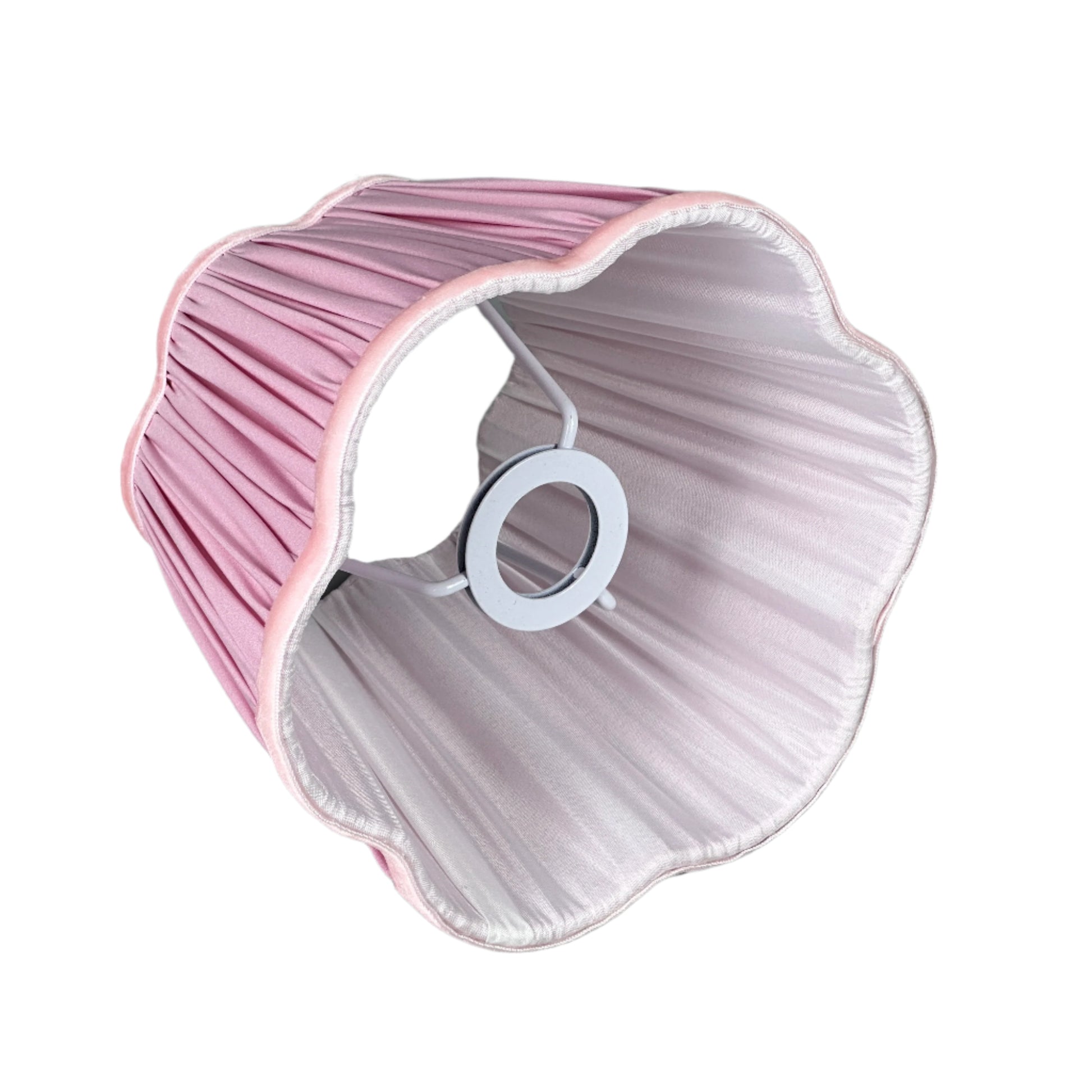 Interior detail shot with brass lamp, book, and soft muted décor.