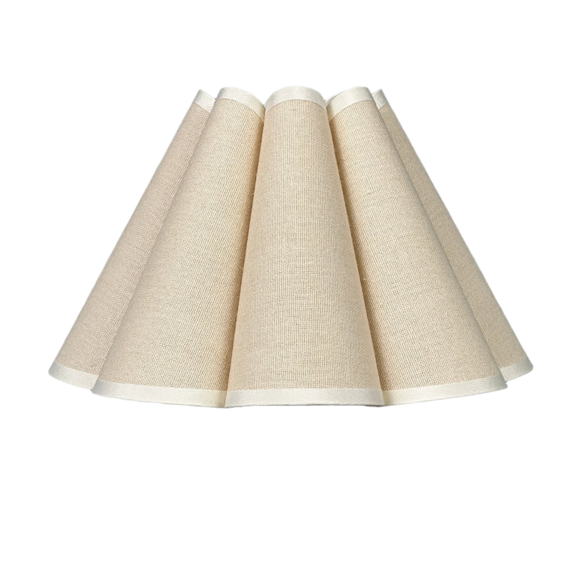 Cozy reading corner with lamp, books and soft seat by window.