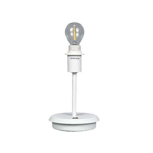 Neutral styled room with brass lamp, vase and textured textiles.