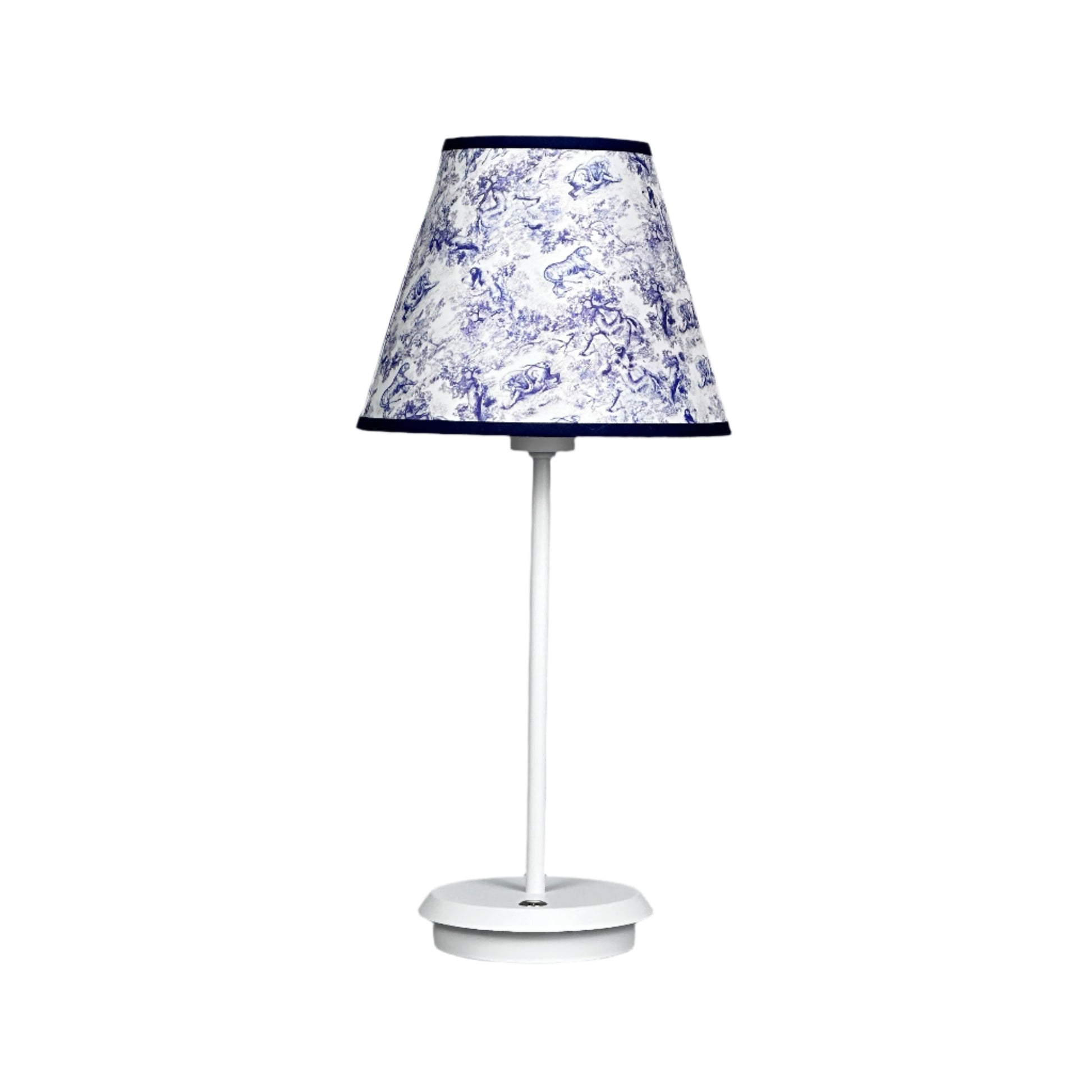 Calm lounge setting with brass lamp, textured rug, and soft décor.