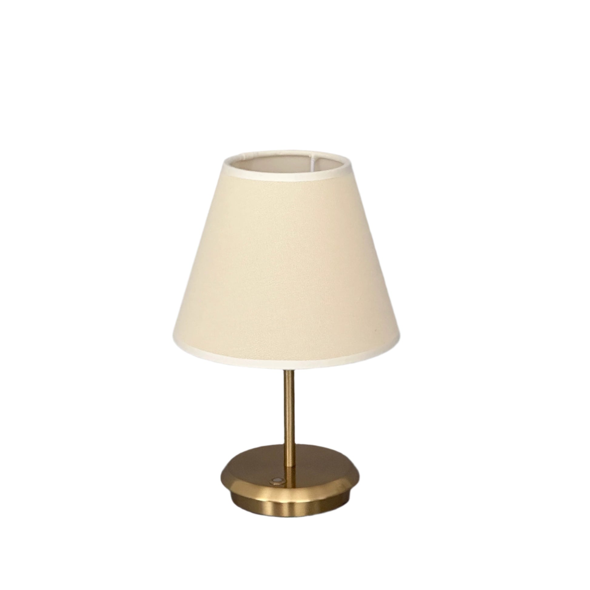 Night interior: brass lamp glowing next to soft seating.